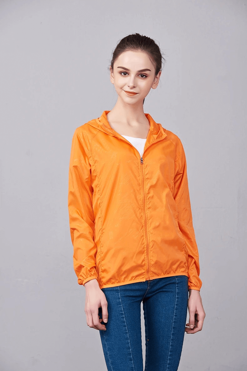 Woman wearing orange Waterproof Polyester Jacket SF2005, ideal for hiking. Lightweight, breathable, sun-protective with anti-UV features.